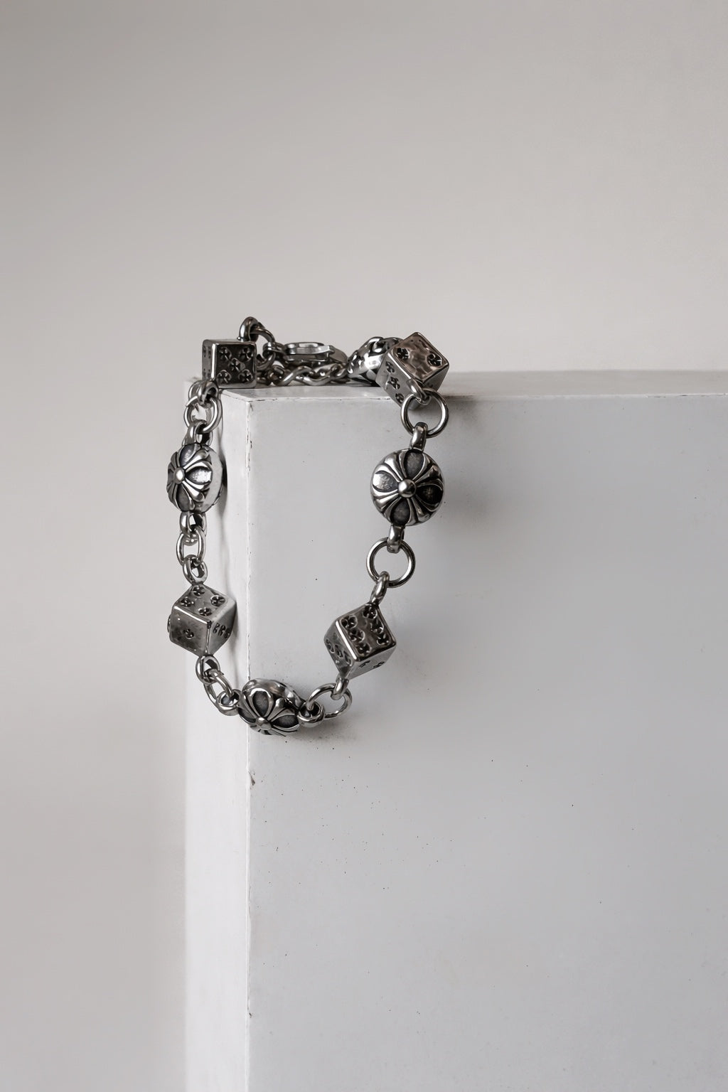 Chrome dice and floral cross motif